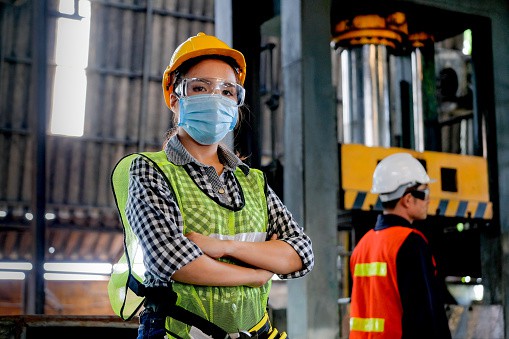 Factory worker with hygienic mask on in factory