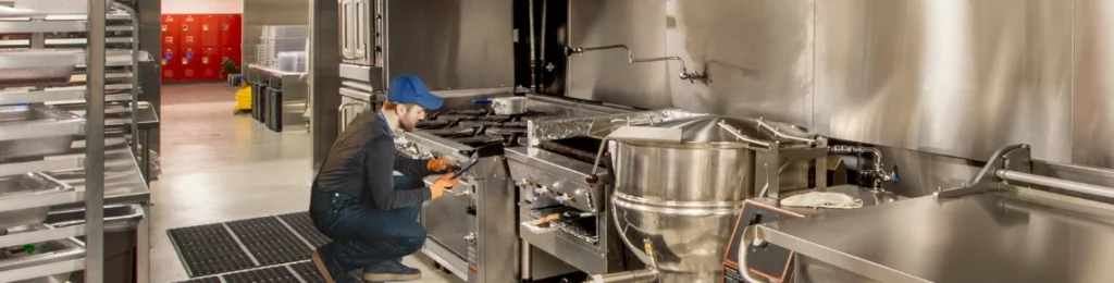 technician working on commercial food equipment