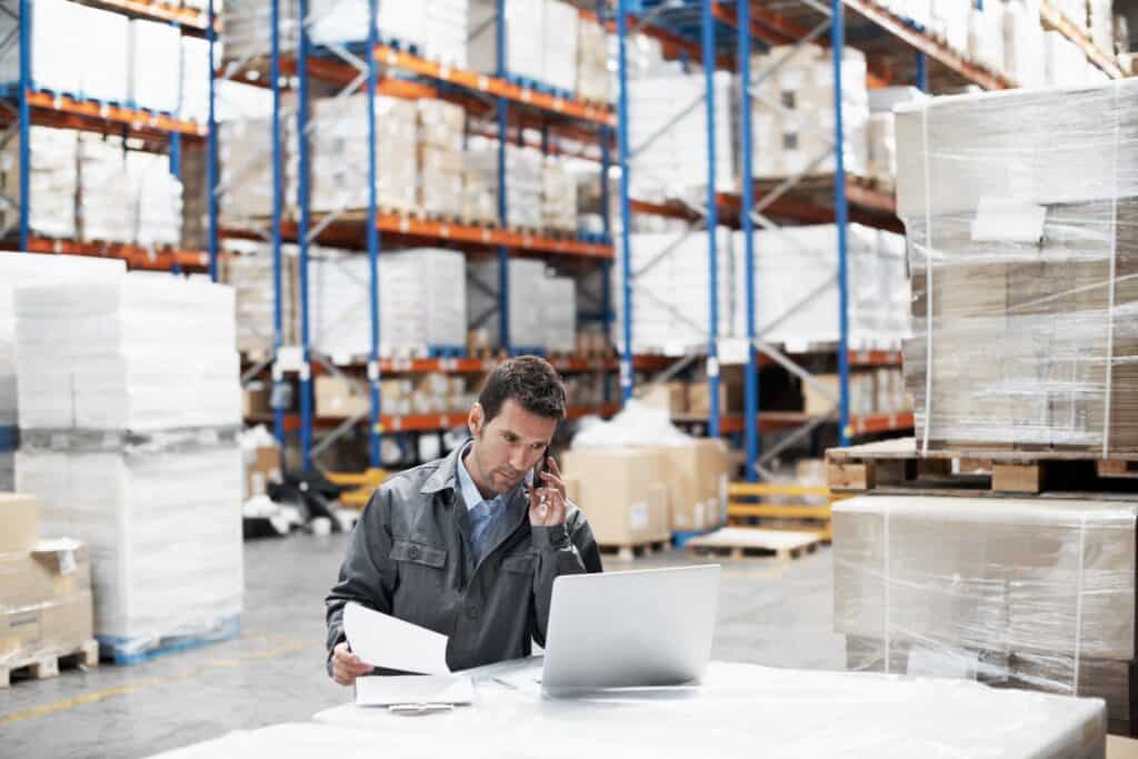 person making calls in factory