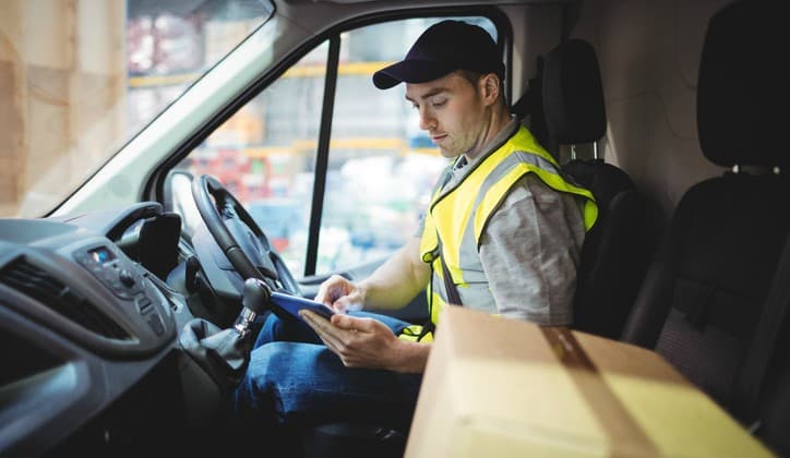 Field Service worker in truck checking inventory