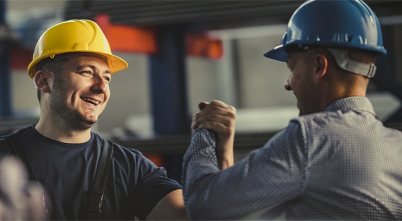 Workers celebrating with high five