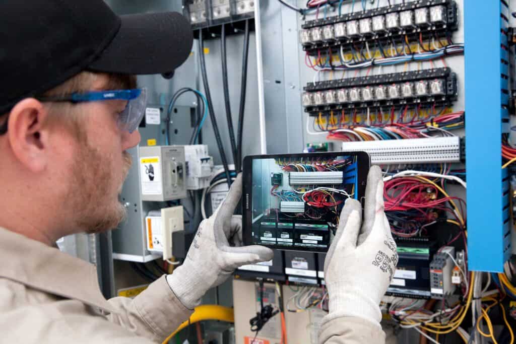 Technician taking picture of cable wires