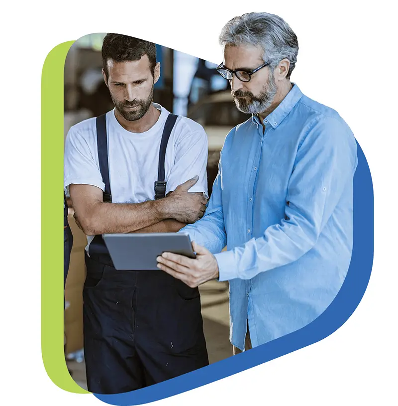 garage workers reviewing a tablet together