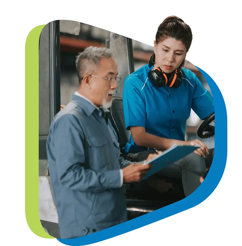 two workers reviewing a clipboard in a warehouse