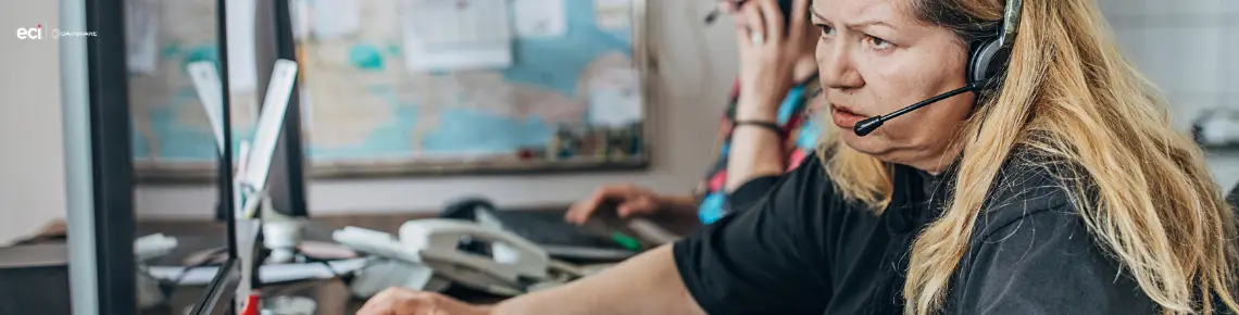 female dispatcher with headset working at computer